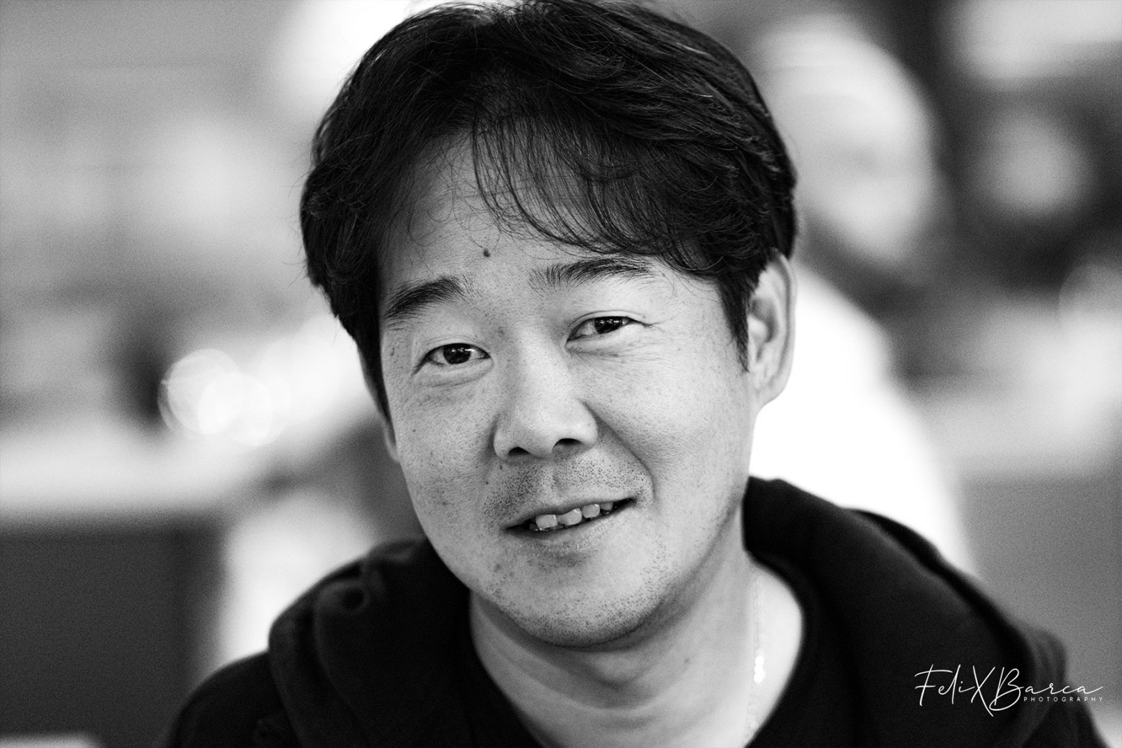 Black and white portrait of Asian man, by Felix Barca